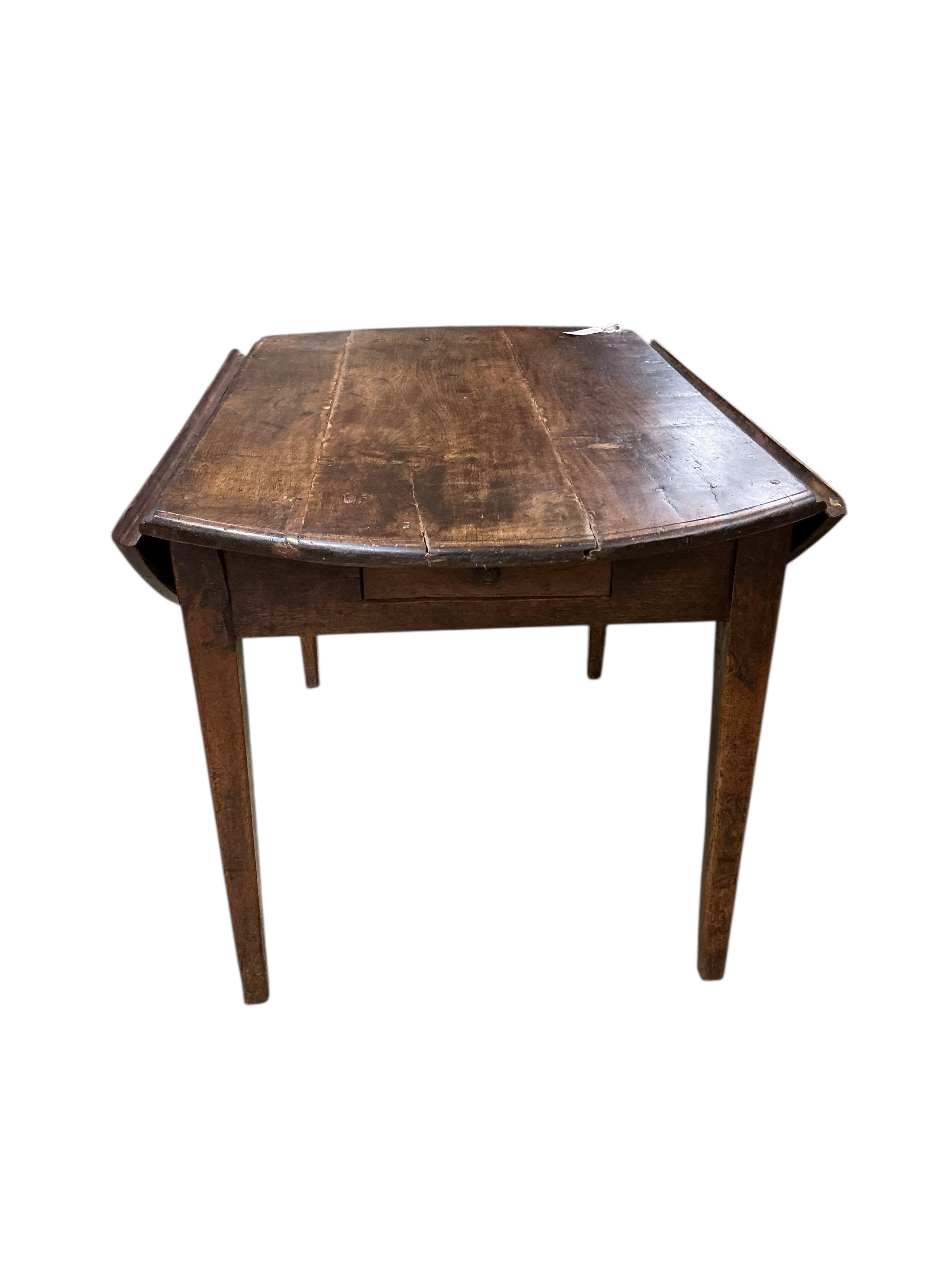 A 19th century French Provincial oak drop leaf table, width 122cm, depth 79cm, height 71cm